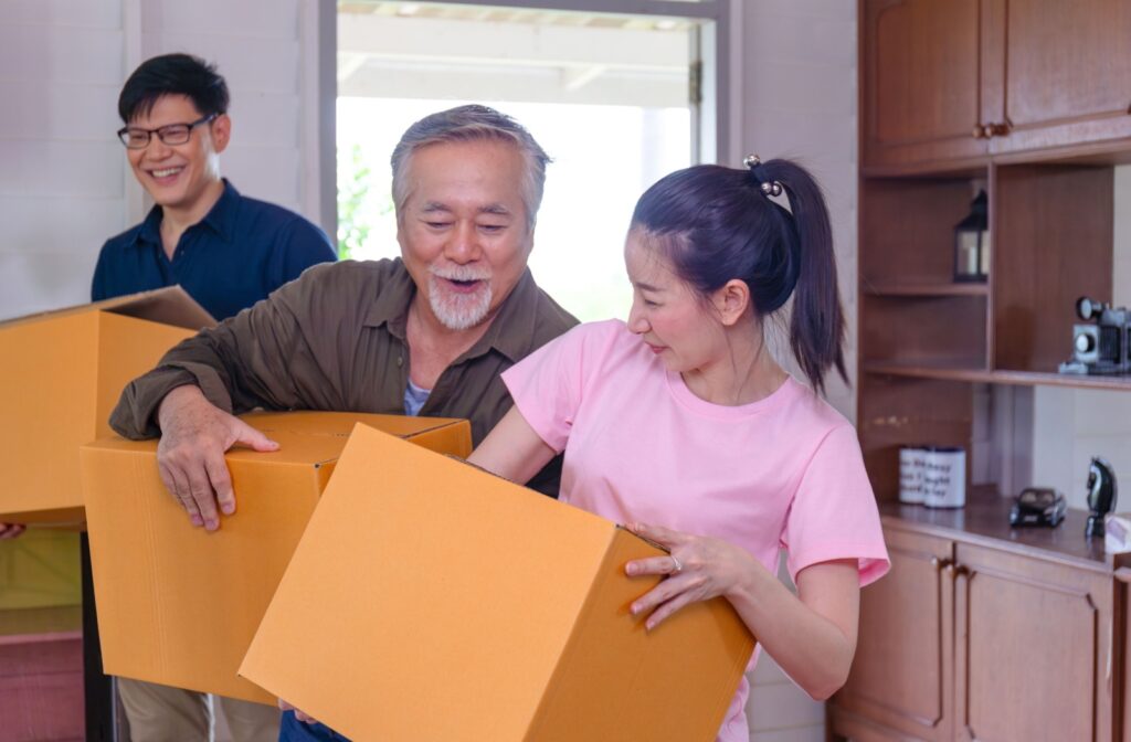 A group of people working together to carry boxes during a downsizing or moving process.