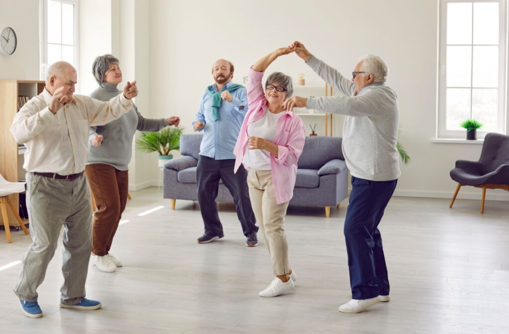 A group of older adults dancing indoors.