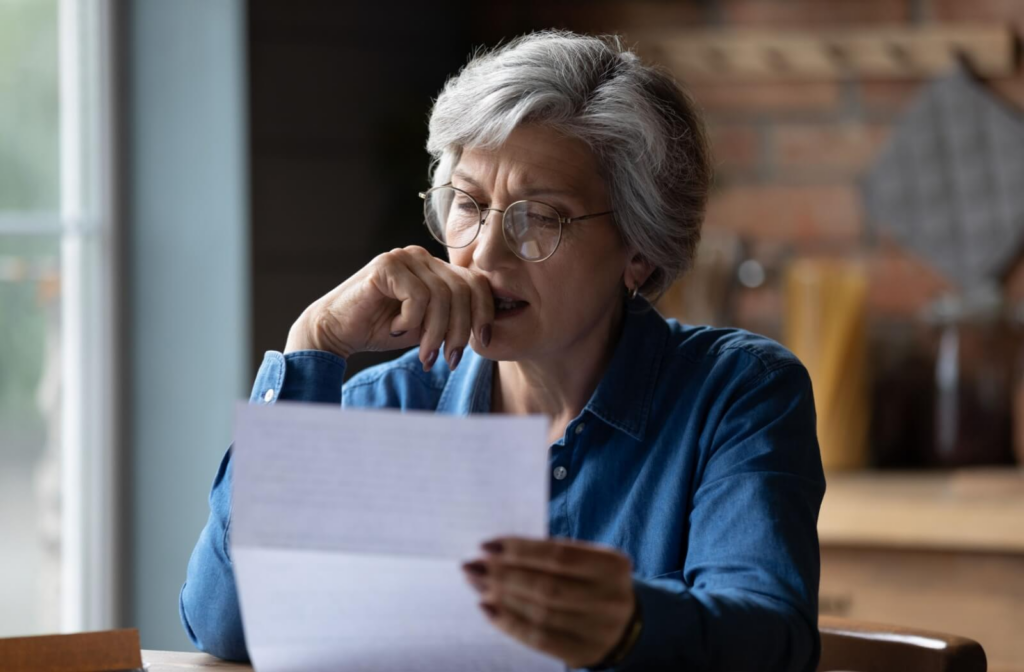 A senior checks and gathers important documents in preparation for applying to assisted living.